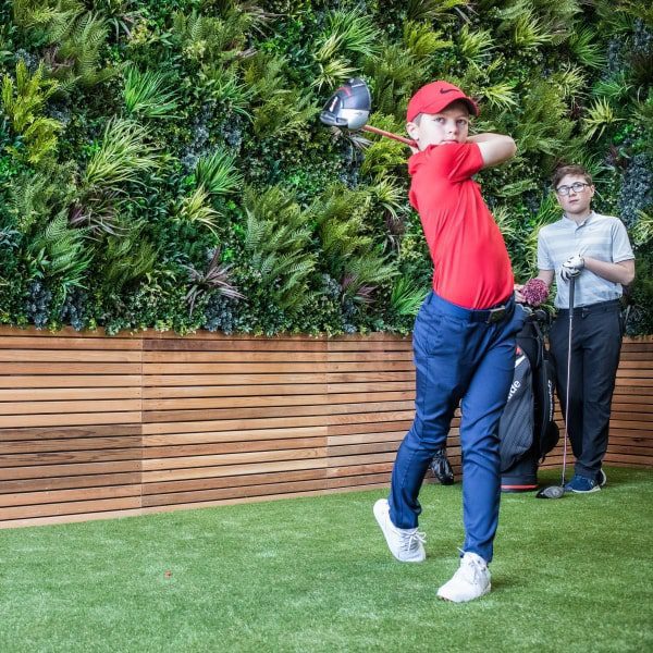 real-looking plant wall children playing golf