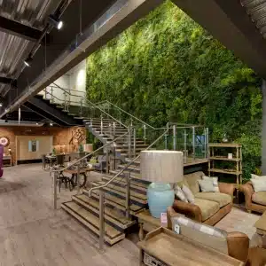 green wall panels behind open plan apartment stairs