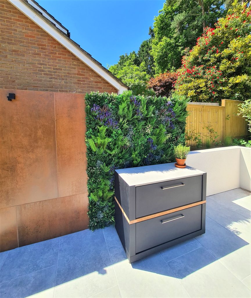 An outdoor artificial green wall in a garden