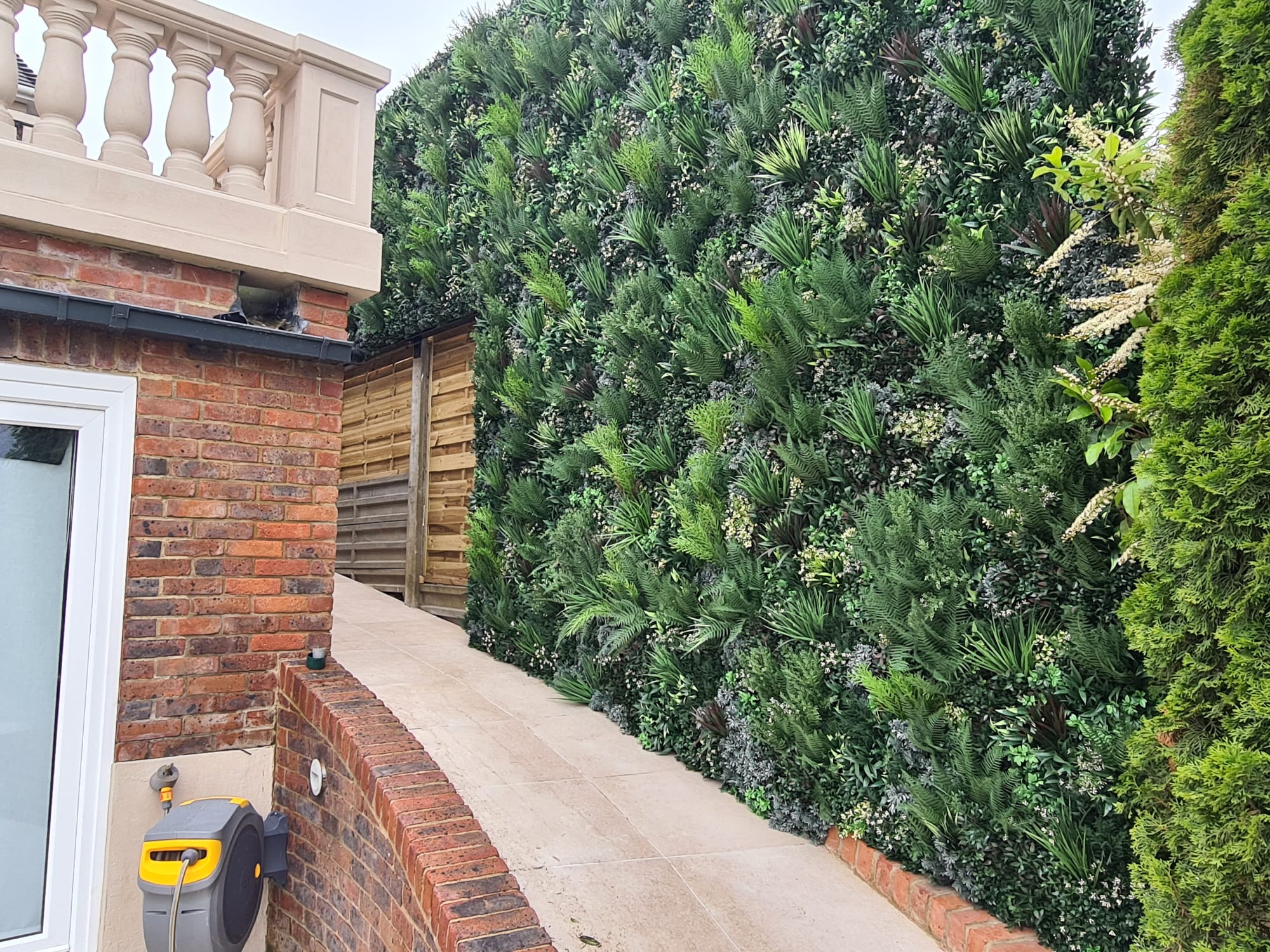 artificial green wall privacy screen in a garden