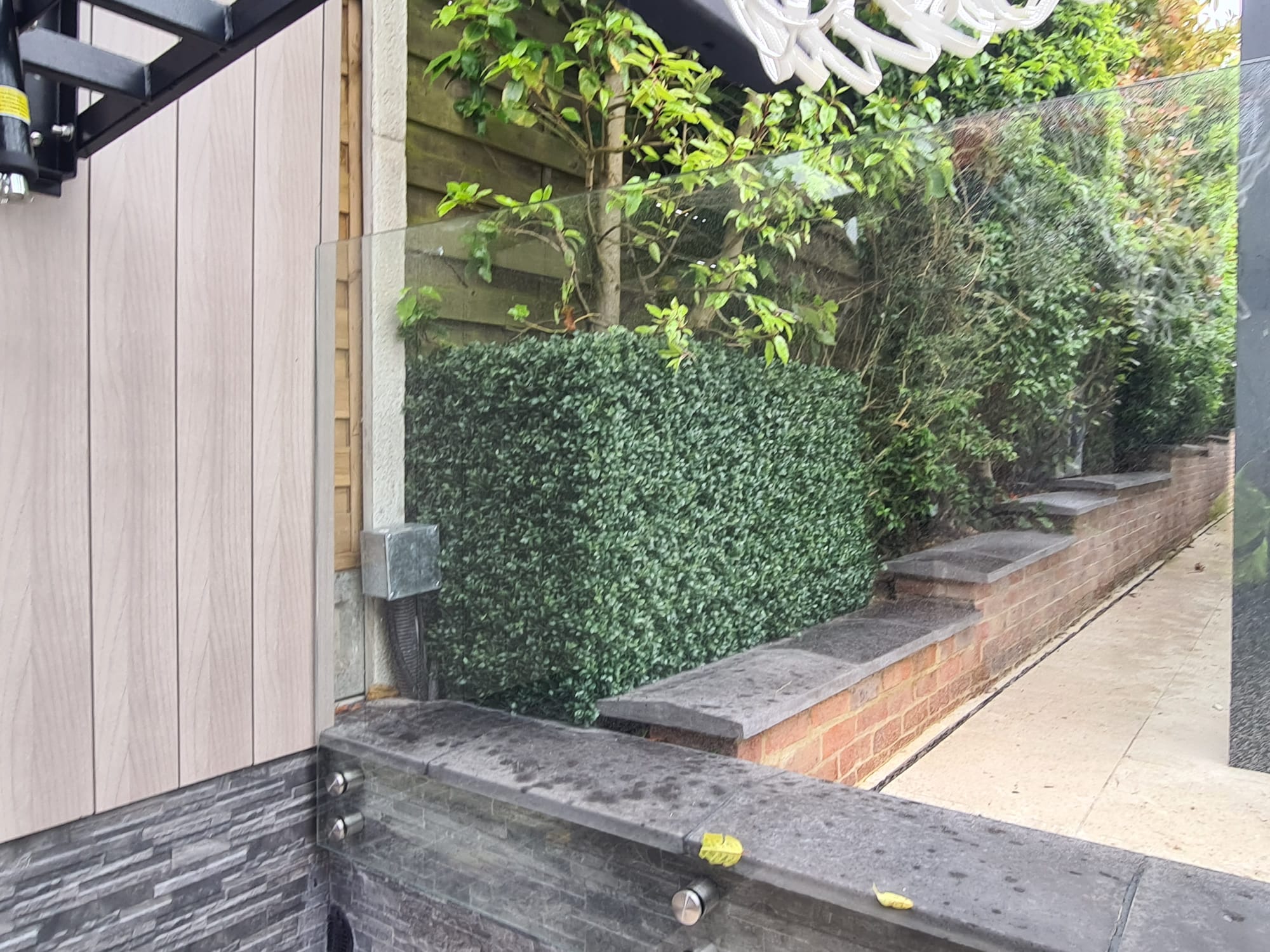 Artificial boxwood panels used to create a hedge