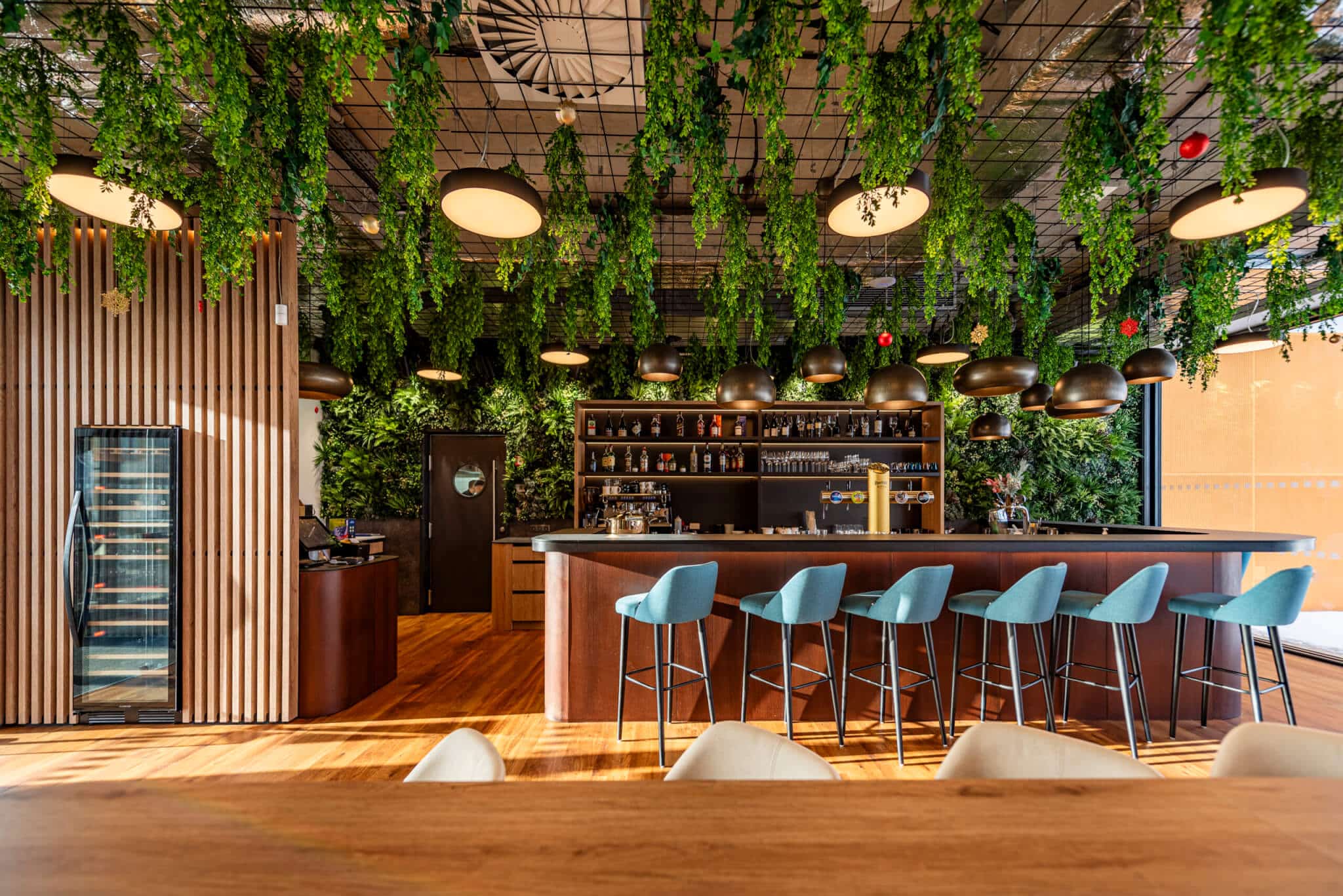 Artificial Green Wall with hanging foliage in bar