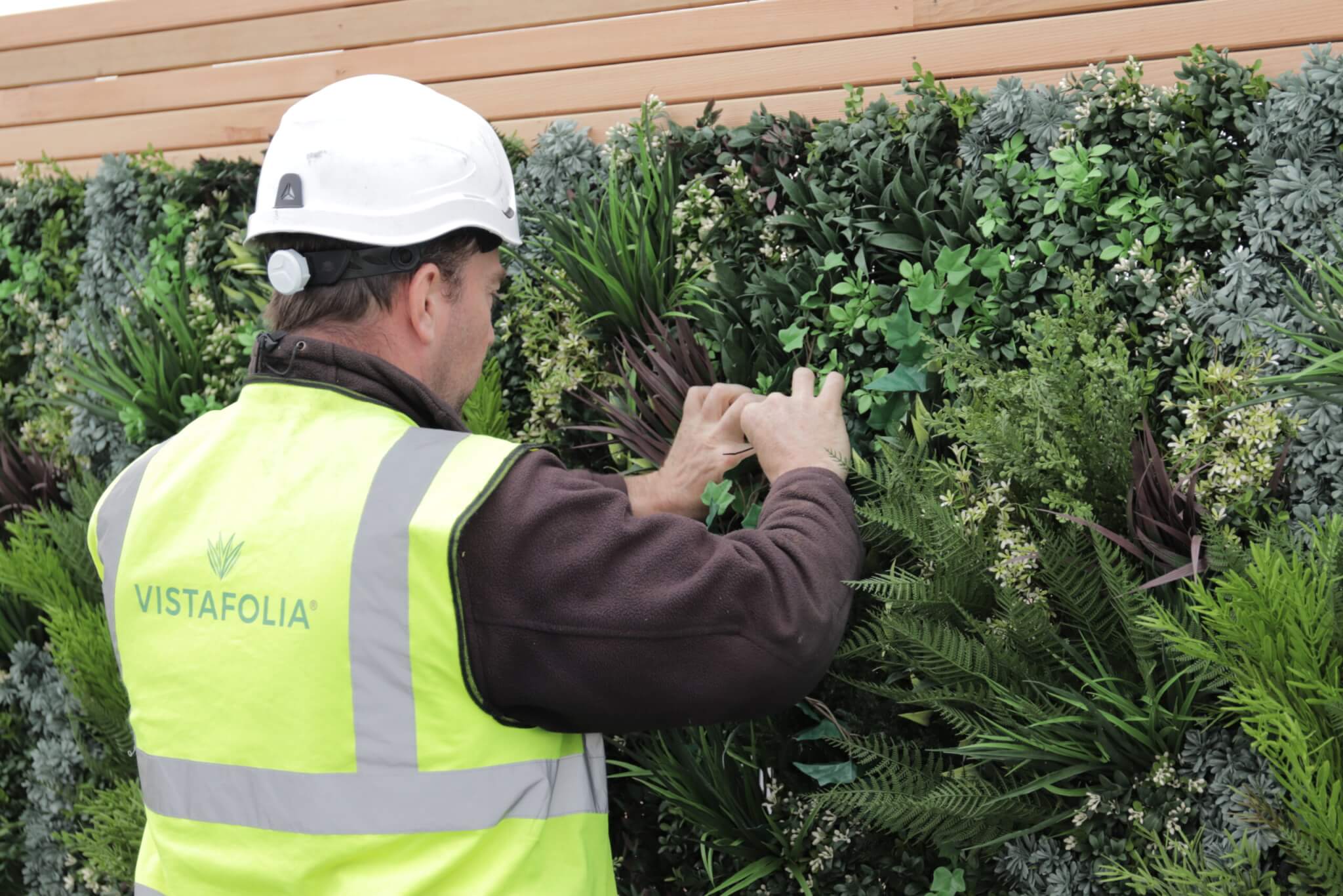 Vistafolia applying final touches to artificial green wall